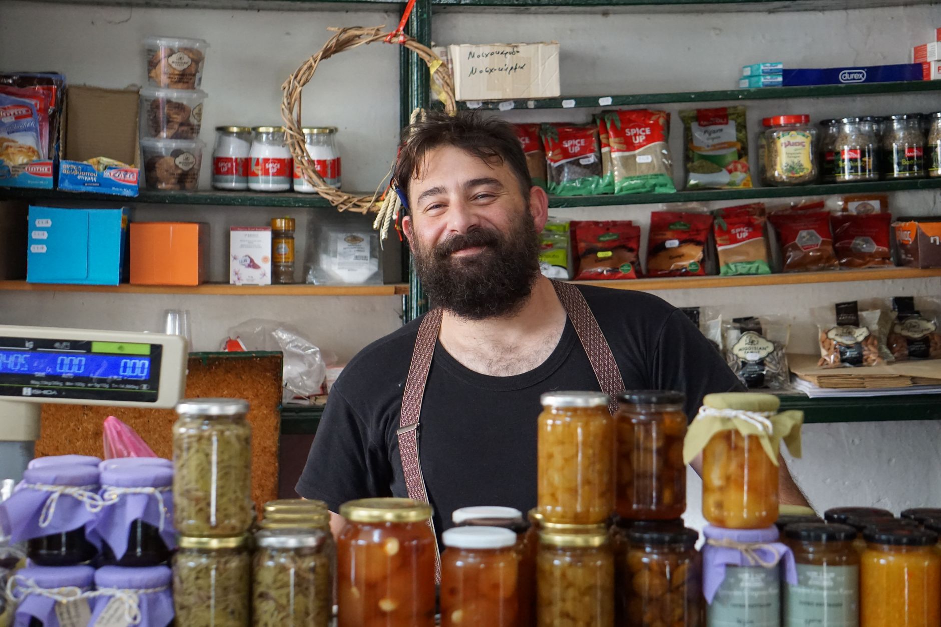 An independent shop owner behind the counter